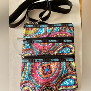 Le Sportsac mini crossbody bag in colorful paisley pattern with black trim